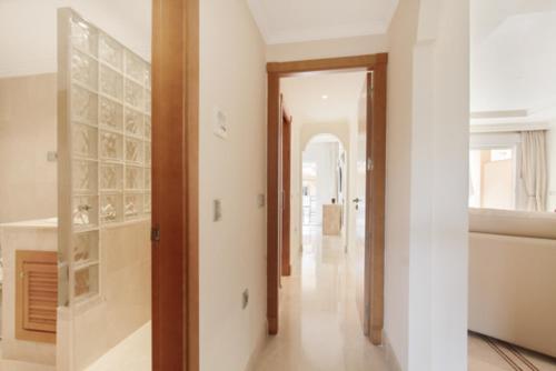 a hallway of a home with white walls at Aloha Hill Club LLuxury 5 Star Golf Resort Near Puerto Banus and Marbella in Marbella