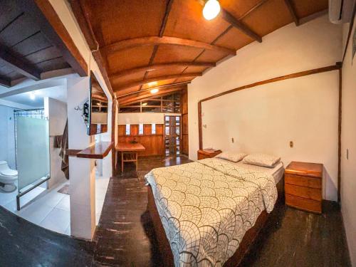 a bedroom with a bed and a desk in it at CASA DEL MAR in Ayangue