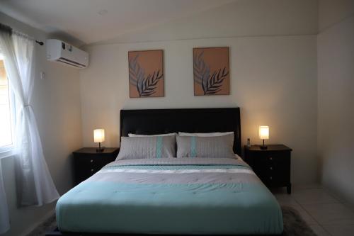 a bedroom with a large bed with two night stands at Tranquil Stay Suite in Gros Islet