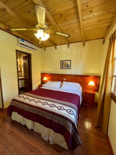 a bedroom with a large bed and a wooden ceiling at Hosteria Sirenuse in Mar del Plata