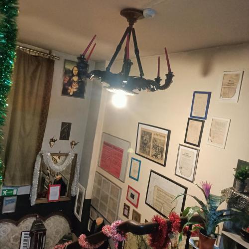 a living room with a chandelier hanging on the wall at Hostel Apollo in Ząbkowice Śląskie