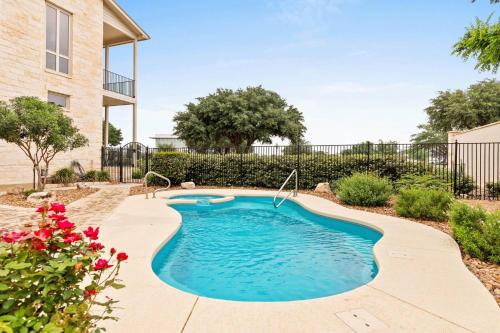 a swimming pool in a yard with flowers at #21 The Silo in Gruene in New Braunfels