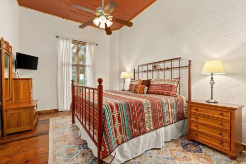 a bedroom with a bed and a ceiling fan at #24 at Gruene Silo Inn in New Braunfels