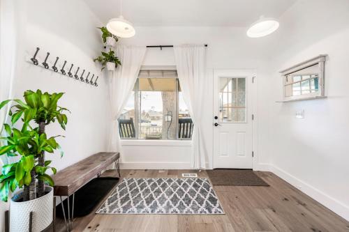 een woonkamer met een bank en een raam bij The Canopy: A Peaceful Home Nestled in Sugarhouse in Salt Lake City