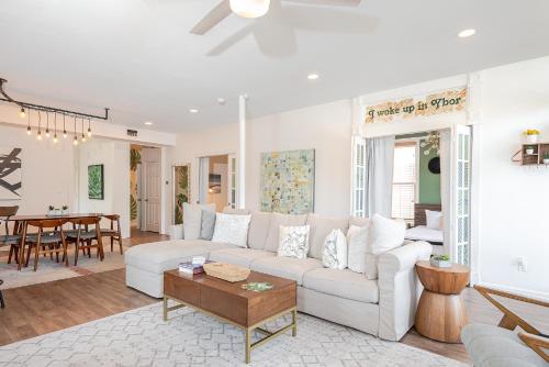 a living room with a white couch and a table at Ybor City Gem I Steps to 7th Ave I Sleeps 6 in Tampa