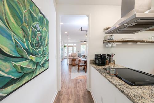 a kitchen with a painting on the wall at Ybor City Gem I Steps to 7th Ave I Sleeps 6 in Tampa