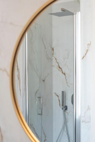 a mirror in a bathroom with a shower at Il Vicoletto sul Mare in Ischia