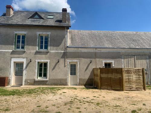 an old house with a wooden fence in front of it at Le Pressoir Macy - Terracobois in Choussy