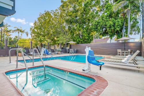 a swimming pool with a slide and a water park at Avania Inn of Santa Barbara in Santa Barbara