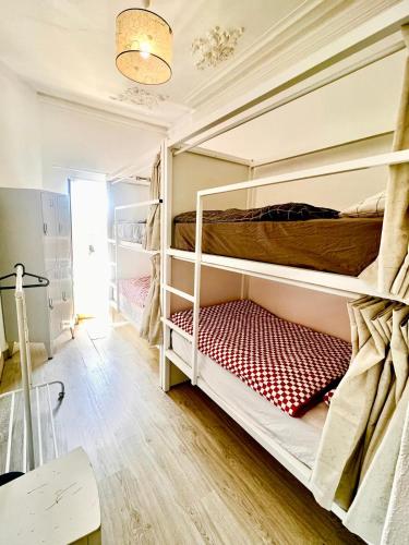 a room with two bunk beds in it at SwissPorto Guest House in Porto