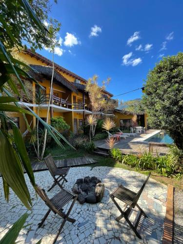 a resort with two chairs and a swimming pool at Pousada In Bali - Maresias in Maresias