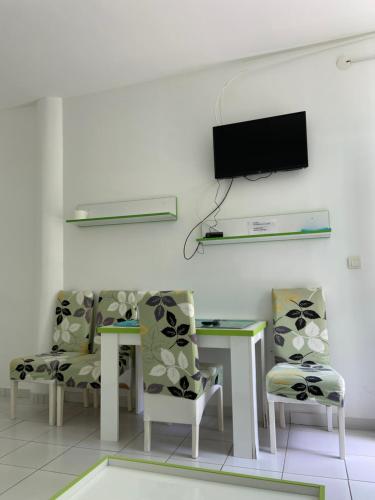 Una habitación con dos sillas y una mesa y un televisor. en Apartmani Jovana, en Soko Banja