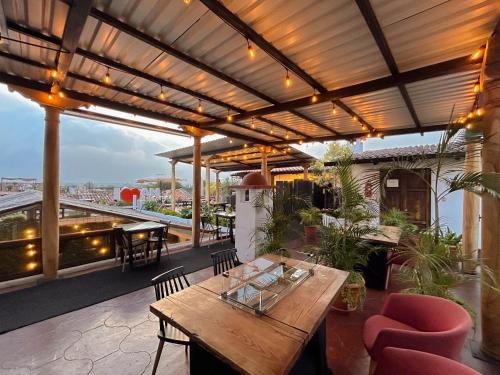 an outdoor patio with a wooden table and chairs at El Carmen Hotel in Antigua Guatemala