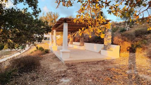 a bench in front of a wooden shelter at Annas Katikia in Drymonas