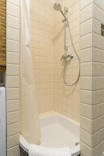 a bathroom with a shower with a tub at P&O Podwale Apartments in Warsaw