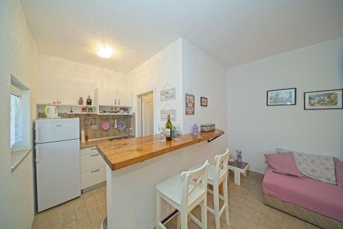 a kitchen with a white refrigerator and a counter top at Apartment Sidro in Postira