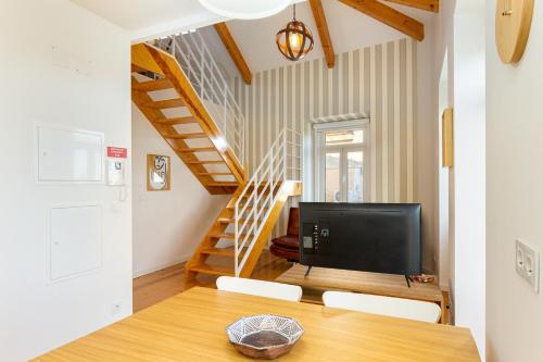 a living room with a table and a television at Arroios Concept Apartments by Homing in Lisbon