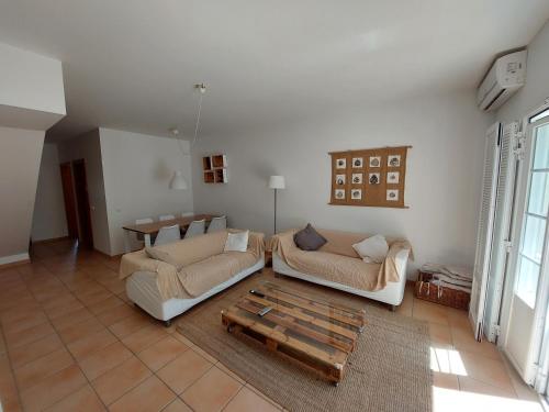 a living room with two couches and a coffee table at Casa Água & Sal in Castro Marim