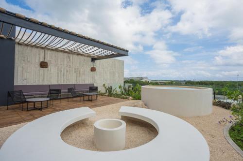 a backyard with a patio with a table and chairs at IIK Tulum Luxury Condo by Spot Rentals in Tulum
