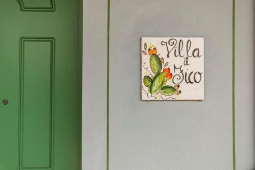 a picture on a wall with a sign on it at Villa Il Fico in Cavriglia