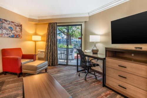 a hotel room with a flat screen tv and a desk at Best Western Plus Wine Country Inn & Suites in Santa Rosa