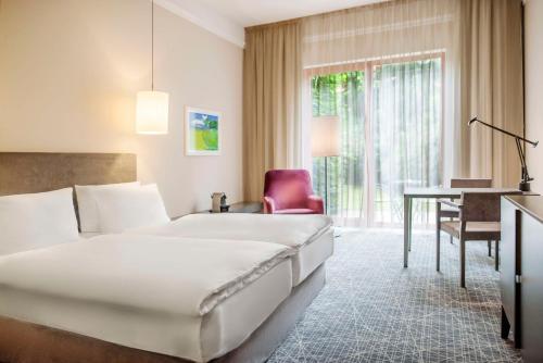 a hotel room with a bed and a desk at NH Collection Prague in Prague