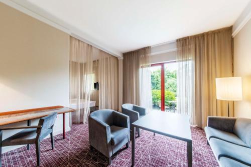 a hotel room with a table and chairs at NH Collection Prague in Prague