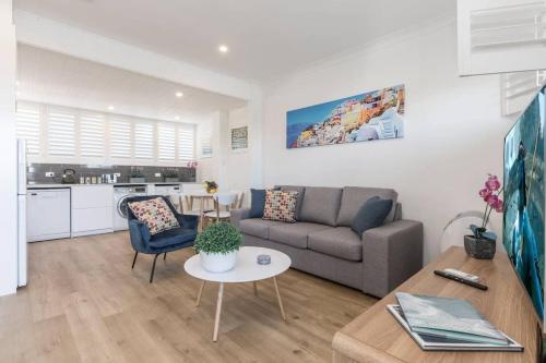 a living room with a couch and a table at Bondi Beach Spacious Apartment in Sydney