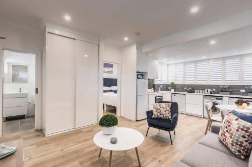a living room with a couch and a table at Bondi Beach Spacious Apartment in Sydney