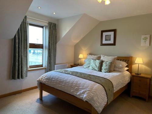 a bedroom with a large bed and a window at Marina House North and Marina House South in Stromness