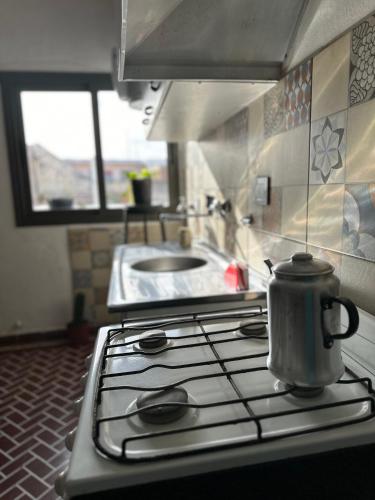 a tea kettle sitting on top of a stove in a kitchen at Casa Ciao in Deán Funes