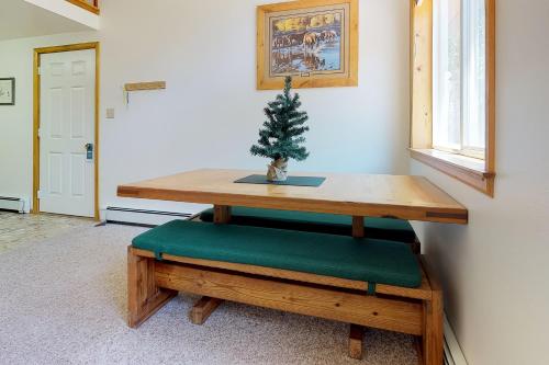 a table with a christmas tree on top of it at Chair Mountain Cabin at Filoha Meadows in Redstone