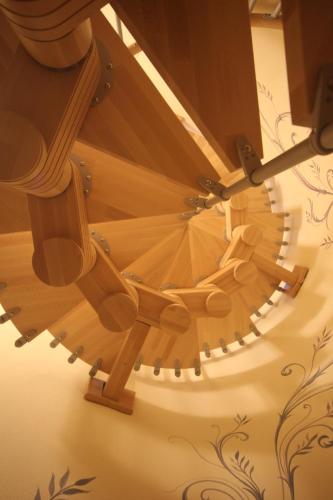 a wooden spiral staircase in a building at Agriturismo Il Barone in Moniga