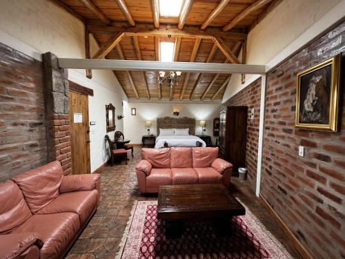 a living room with a couch and a bed at Hacienda Jimenita Wildlife Reserve in Puembo