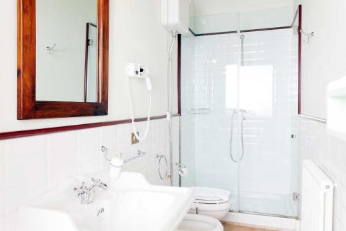 a bathroom with a shower and a sink and a toilet at Le Mandrie Di San Paolo in Assisi