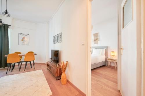 a bedroom with a bed and a dining room with a table at Sunny - Cozy Apartment in Amadora