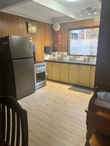 a kitchen with a refrigerator and a stove at Huntinaddi Lodge in Halls Gap