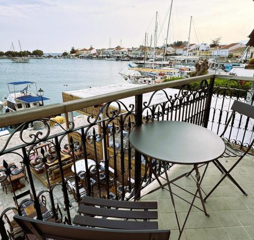 a table and chairs on a balcony overlooking a marina at The Stonehouse at the Harbor in Pythagoreio
