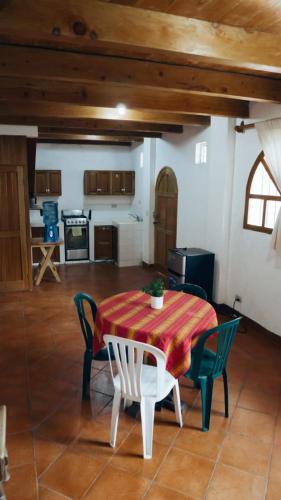 a table and chairs in a room with a kitchen at Hostal Dulces Sueños in Panajachel