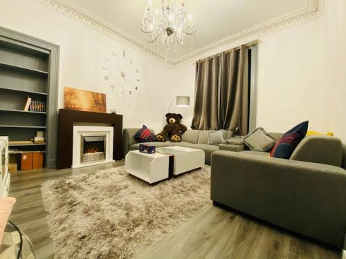 a living room with a couch and a fireplace at Golfers lovers! Near all famous golf courses in Prestwick