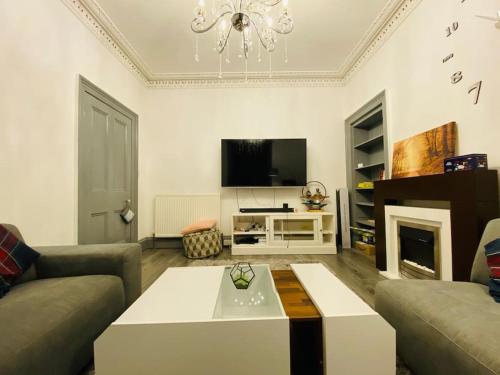 a living room with a couch and a coffee table at Golfers lovers! Near all famous golf courses in Prestwick