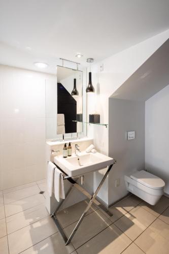 a bathroom with a sink and a mirror at Queenstown Park Boutique Hotel in Queenstown