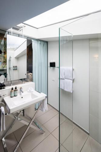 a bathroom with a sink and a shower at Queenstown Park Boutique Hotel in Queenstown