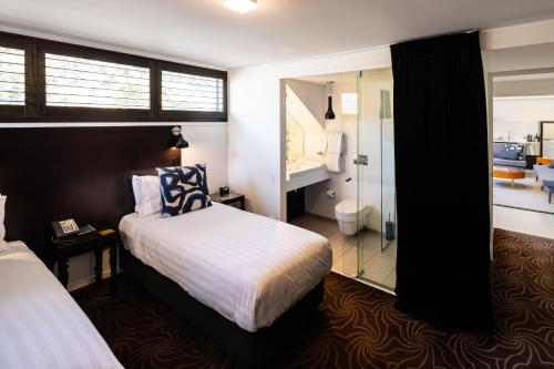 a hotel room with a bed and a bathroom at Queenstown Park Boutique Hotel in Queenstown