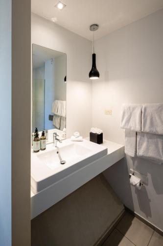 a bathroom with a sink and a mirror at Queenstown Park Boutique Hotel in Queenstown