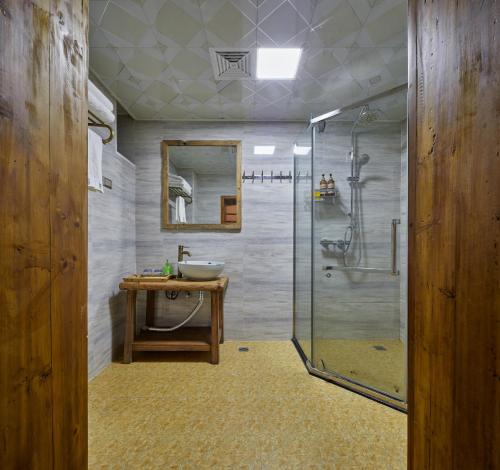 a bathroom with a sink and a shower at Yangshuo Yunshe Mountain Guesthouse in Yangshuo