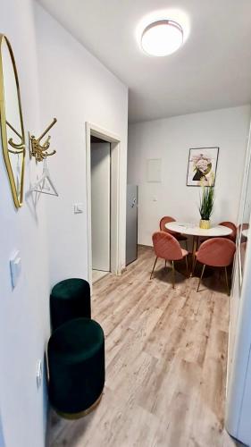 a living room with a table and chairs at Ljubljana Central Lux Apartment with Free Parking in Ljubljana