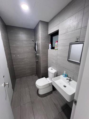 a bathroom with a toilet and a sink at Twentyfive7 Amber Residence in Shah Alam