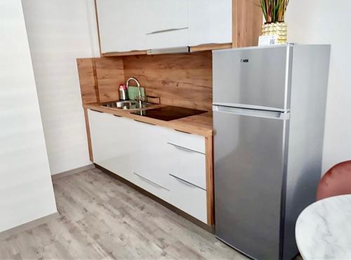 a kitchen with a refrigerator and a sink at Ljubljana Central Studio with Free Parking in Ljubljana