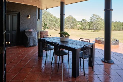 a black table and chairs on a patio at The Caretakers Cottage in Belford